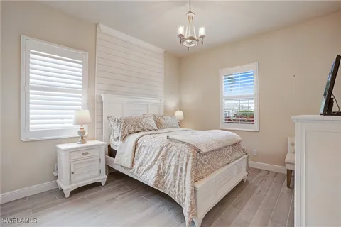 a bedroom with a bed a window and dresser