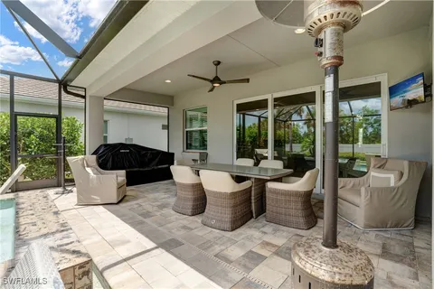 a view of a patio with a dining table and chairs