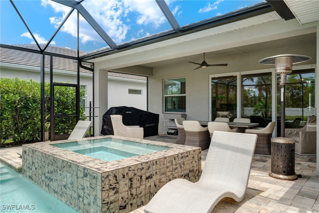 9292 Cayman Drive Naples, FL 34114 - Photo 31 of 50 a living room with furniture a flat screen tv and a large window