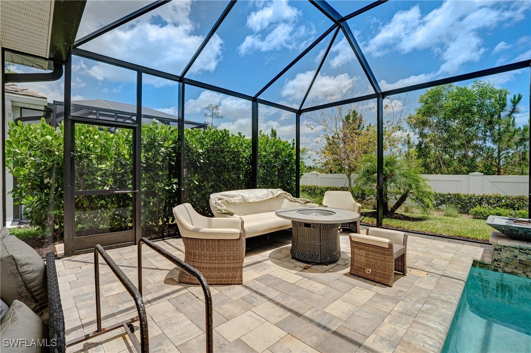 9292 Cayman Drive Naples, FL 34114 - Photo 32 of 50 a view of a patio with a dining table and chairs