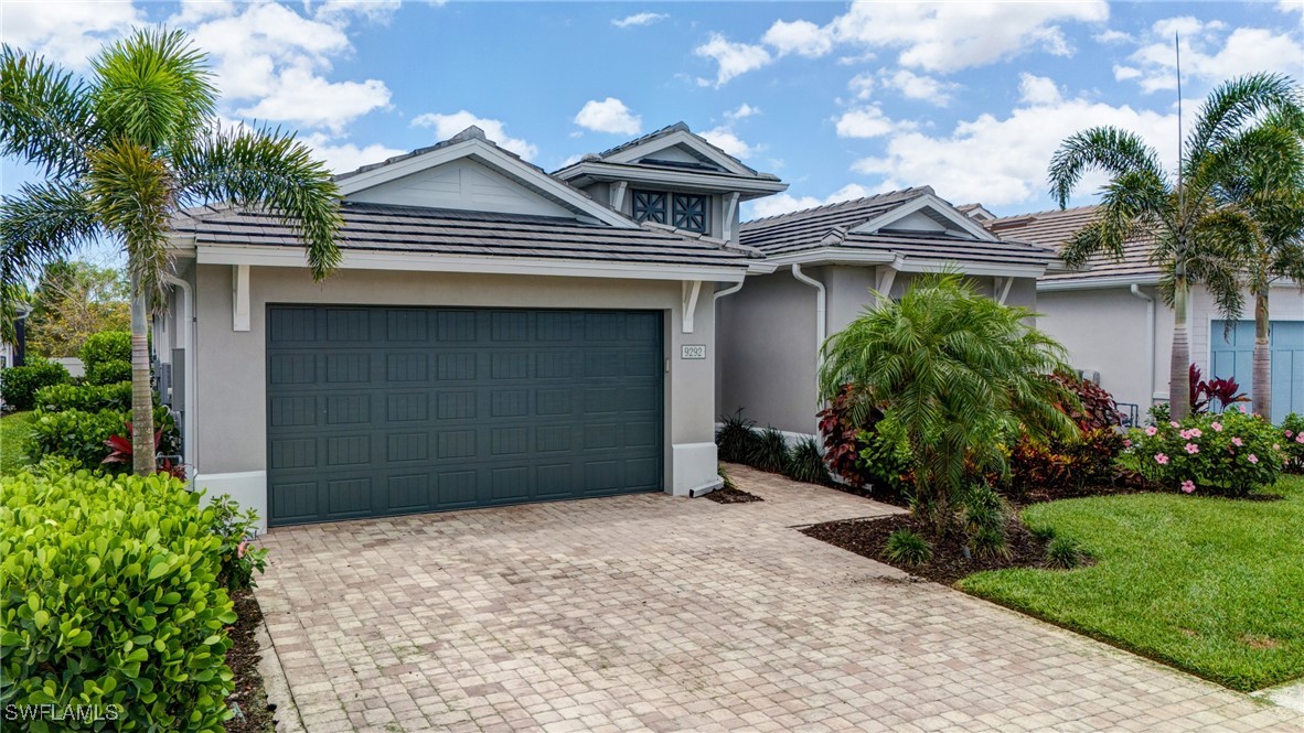 9292 Cayman Drive Naples, FL 34114 - Photo 34 of 50 a front view of a house with a garden
