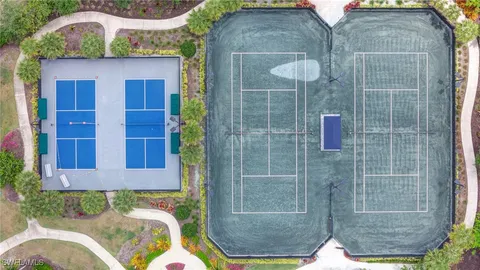 a front view of multi story residential apartment building with yard and entryway