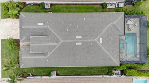 a dining room with stainless steel appliances kitchen island granite countertop a table and chairs