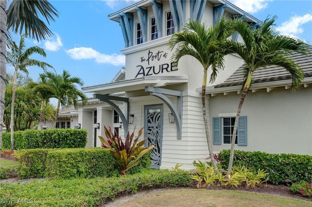 9292 Cayman Drive Naples, FL 34114 - Photo 40 of 50 a front view of multi story residential apartment building with yard and entryway