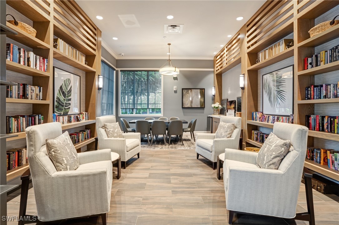 9292 Cayman Drive Naples, FL 34114 - Photo 43 of 50 a living room with furniture and a book shelf