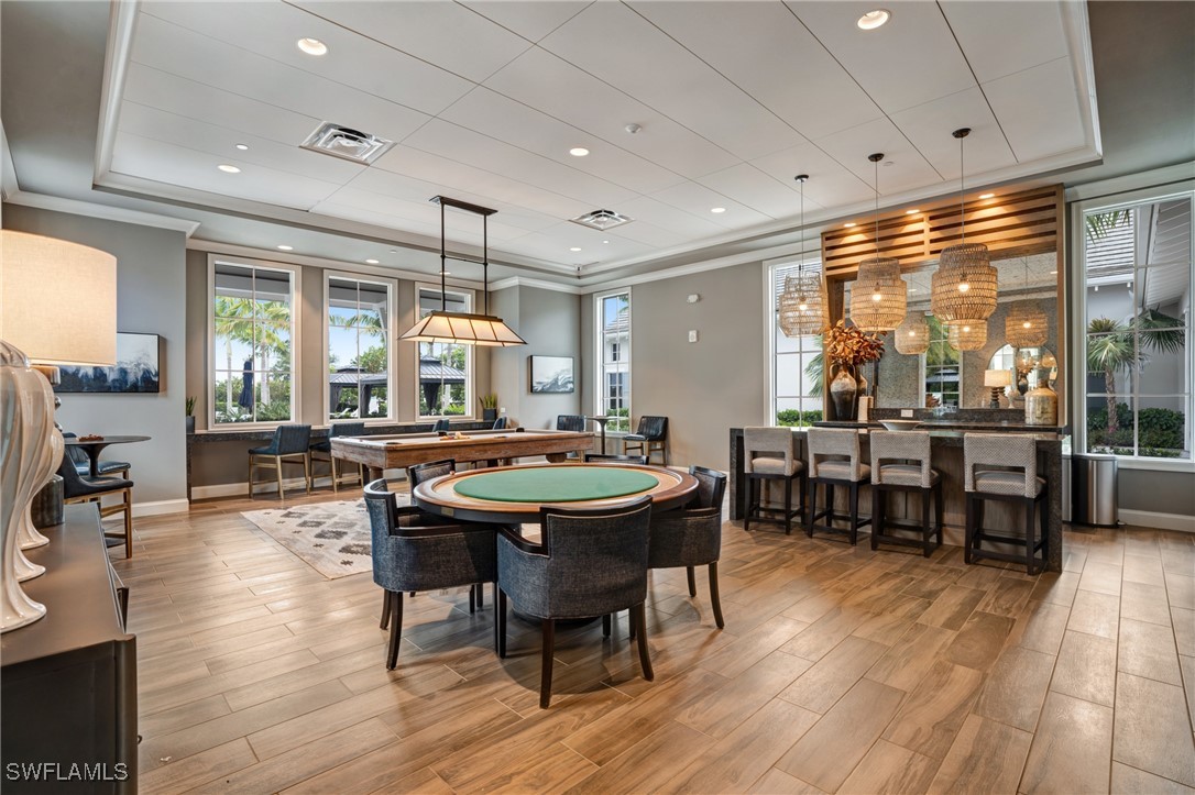9292 Cayman Drive Naples, FL 34114 - Photo 44 of 50 a view of a dining room with furniture window and wooden floor