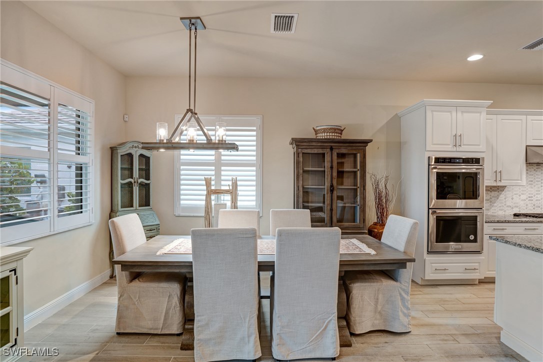 9292 Cayman Drive Naples, FL 34114 - Photo 7 of 50 a view of a dining room with furniture window and outside view