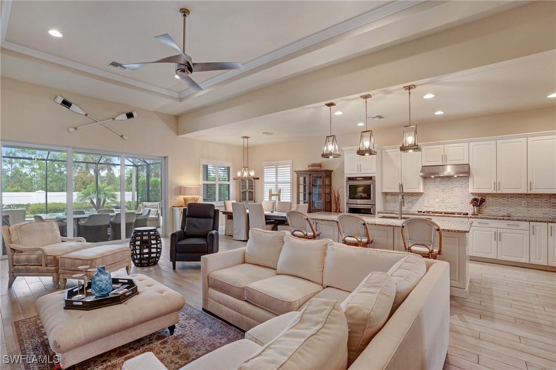 9292 Cayman Drive Naples, FL 34114 - Photo 9 of 50 a living room with furniture kitchen view and a large window