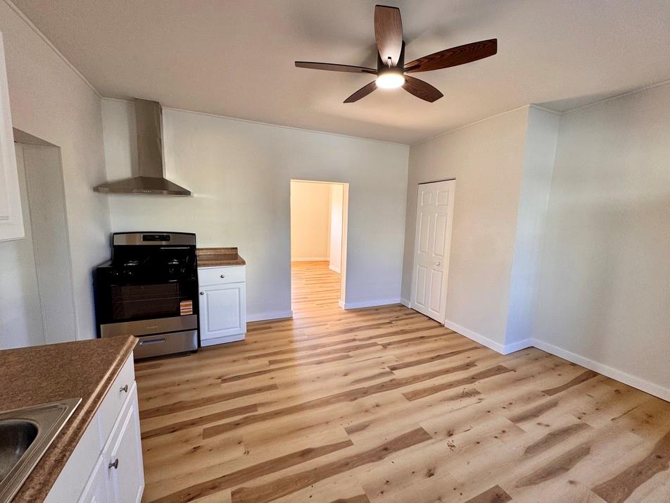 1332 Goettmann Street, Unit 3 Pittsburgh, PA 15212 - Photo 11 of 24 a kitchen with stainless steel appliances granite countertop a stove cabinets and wooden floor