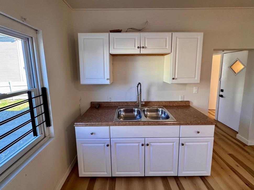 1332 Goettmann Street, Unit 3 Pittsburgh, PA 15212 - Photo 12 of 24 a kitchen with granite countertop a sink a stove and cabinets
