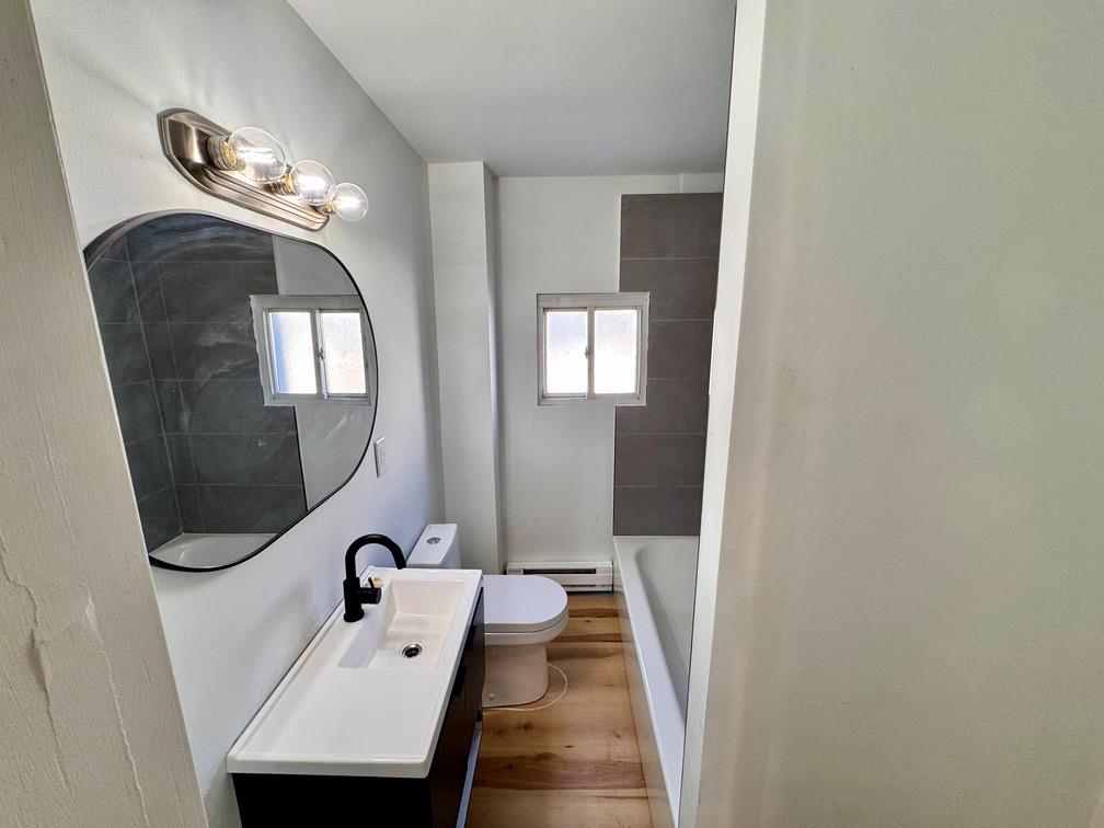 1332 Goettmann Street, Unit 3 Pittsburgh, PA 15212 - Photo 14 of 24 a bathroom with a sink and mirror with bathtub