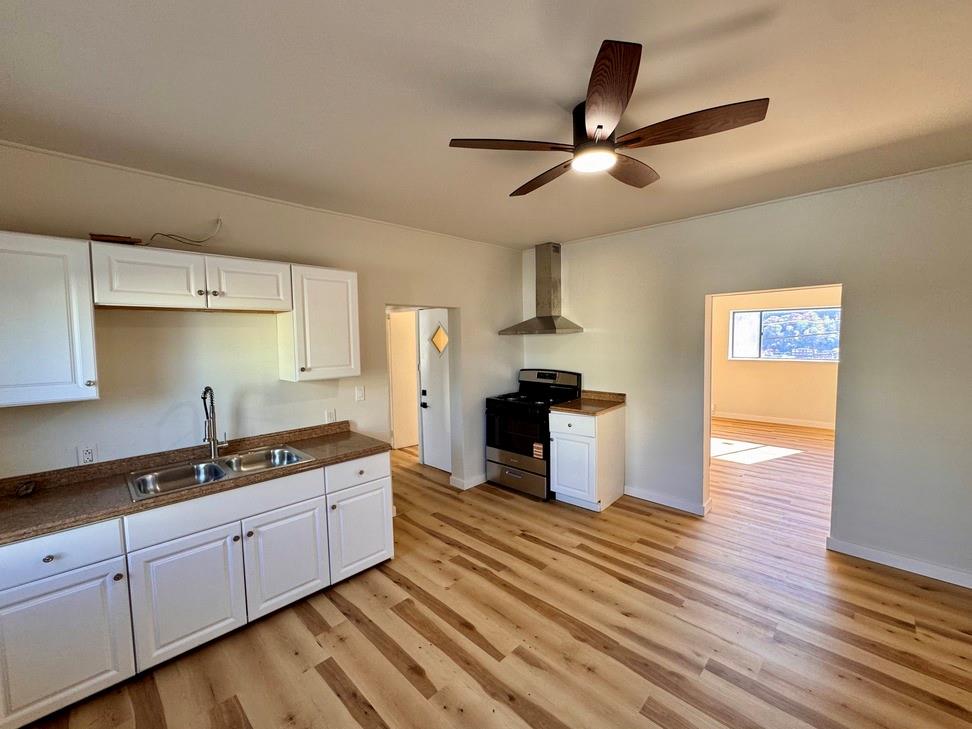 1332 Goettmann Street, Unit 3 Pittsburgh, PA 15212 - Photo 10 of 24 a kitchen with cabinets and wooden floor