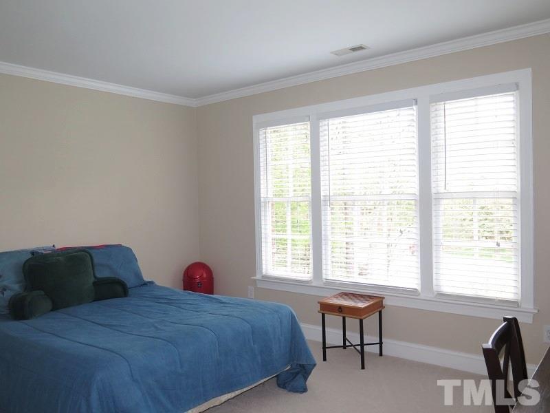 809 Nolstead Court Raleigh, NC 27614 - Photo 14 of 23 a bedroom with a bed and a window