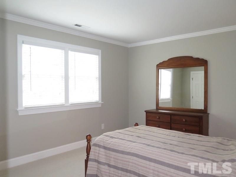 809 Nolstead Court Raleigh, NC 27614 - Photo 15 of 23 a bedroom with a bed and a mirror