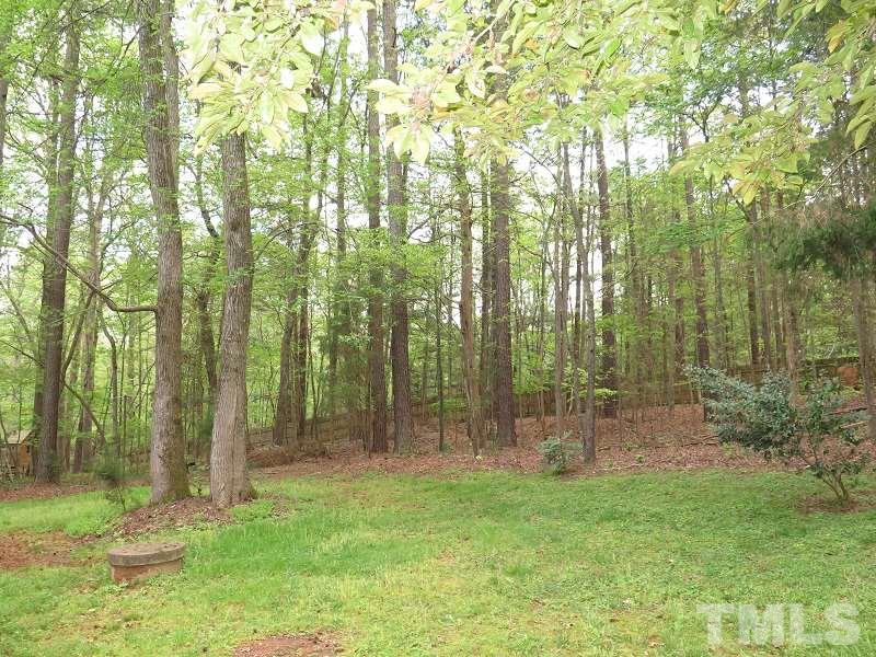 809 Nolstead Court Raleigh, NC 27614 - Photo 23 of 23 a backyard of a house with lots of green space and garden