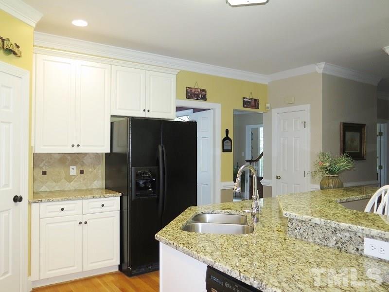 809 Nolstead Court Raleigh, NC 27614 - Photo 6 of 23 a kitchen with a refrigerator sink and cabinets