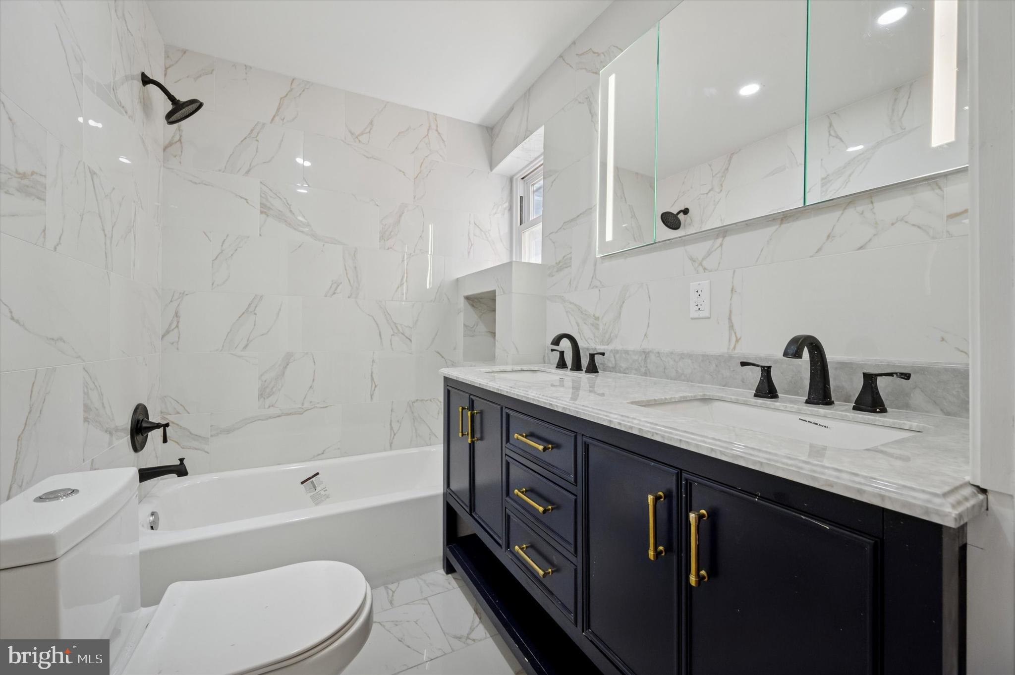 6212 Callowhill Street Philadelphia, PA 19151 - Photo 20 of 23 a spacious bathroom with a granite countertop sink mirror and bathtub