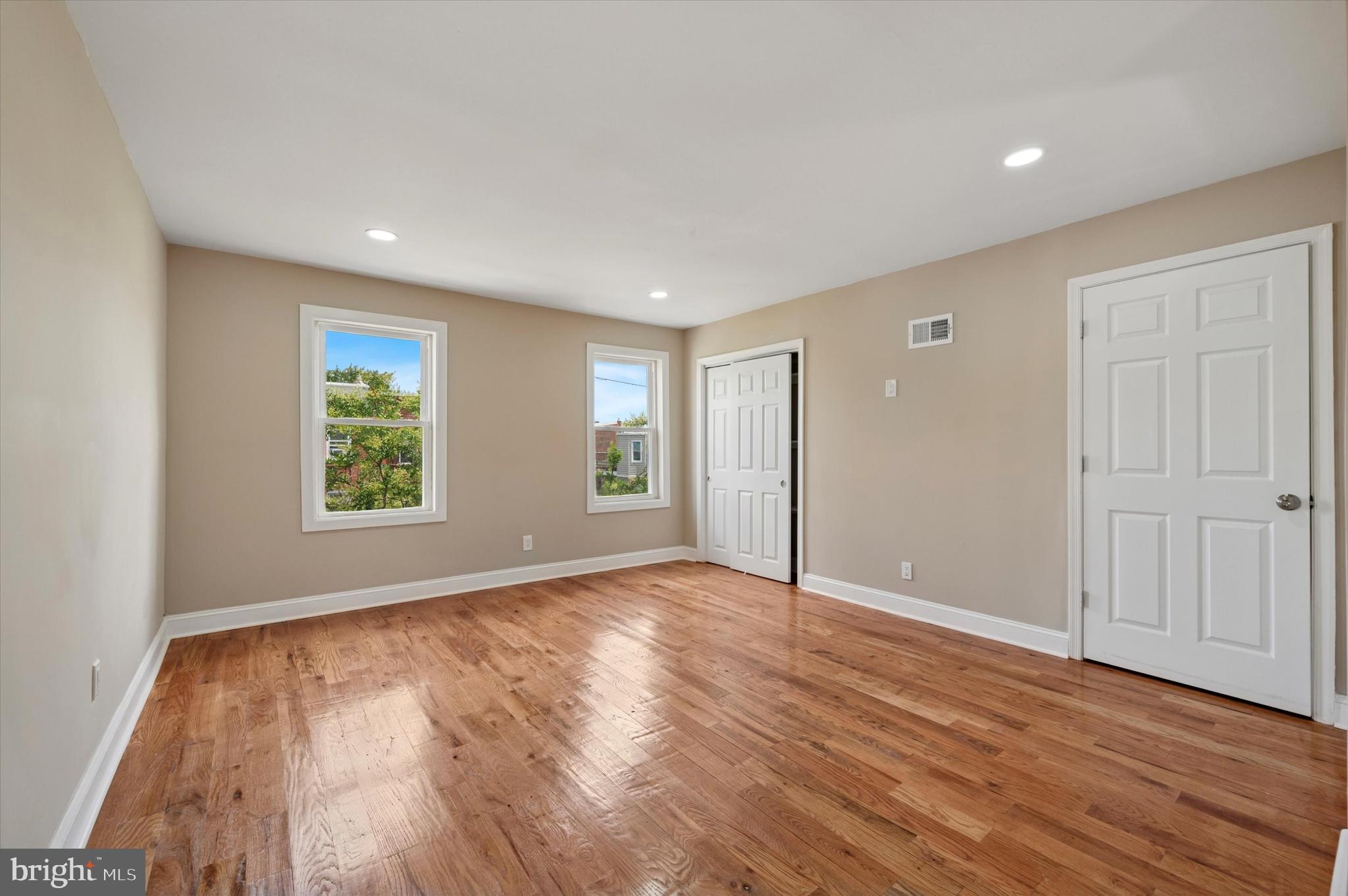 6212 Callowhill Street Philadelphia, PA 19151 - Photo 21 of 23 an empty room with wooden floor and windows