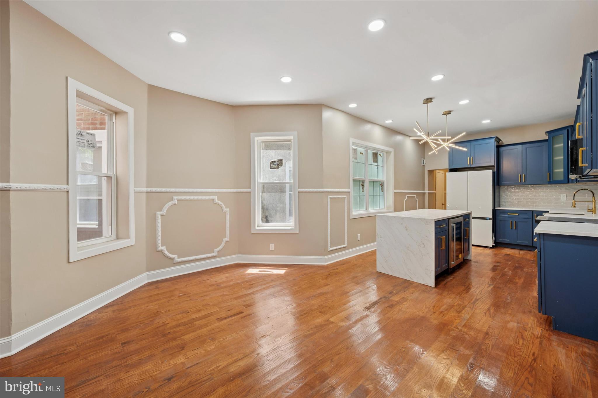 6212 Callowhill Street Philadelphia, PA 19151 - Photo 5 of 23 a view of kitchen with stainless steel appliances granite countertop a stove top oven a sink a refrigerator white cabinets and wooden floor