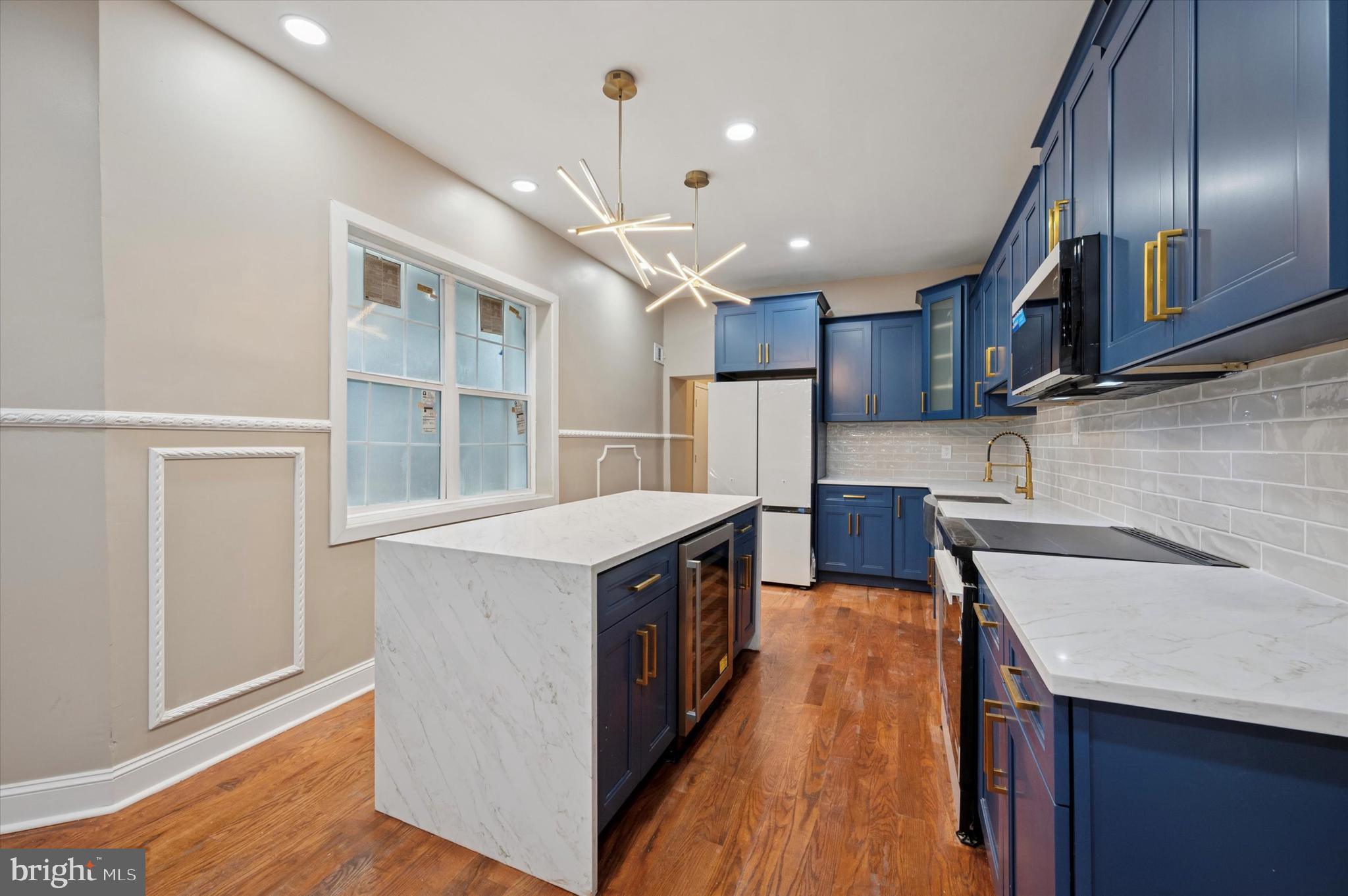 6212 Callowhill Street Philadelphia, PA 19151 - Photo 7 of 23 a kitchen with stainless steel appliances granite countertop a sink a stove and a refrigerator