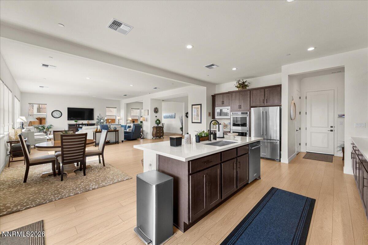348 South Pah Rah Rdg Drive Sparks, NV 89441 - Photo 18 of 45 a large white kitchen with lots of counter space a sink appliances and a dining table