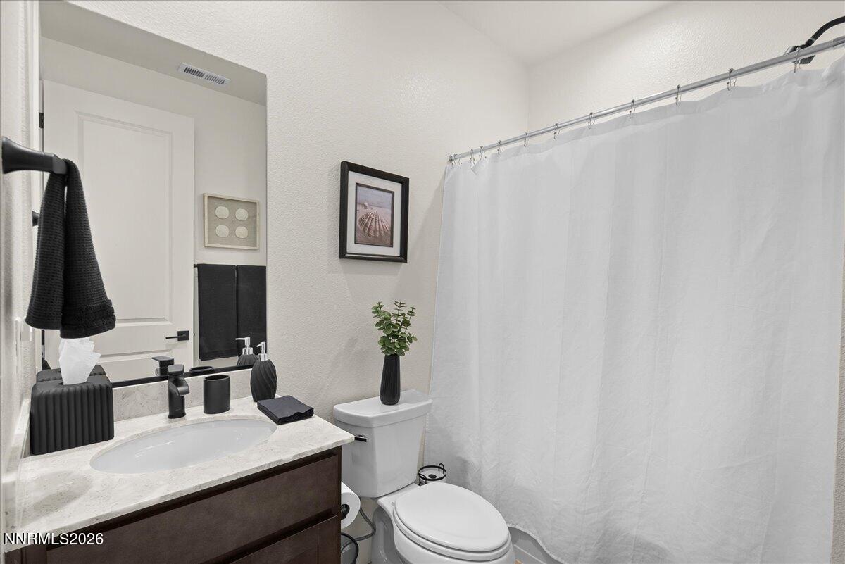 348 South Pah Rah Rdg Drive Sparks, NV 89441 - Photo 23 of 45 a bathroom with a granite countertop sink toilet and a mirror