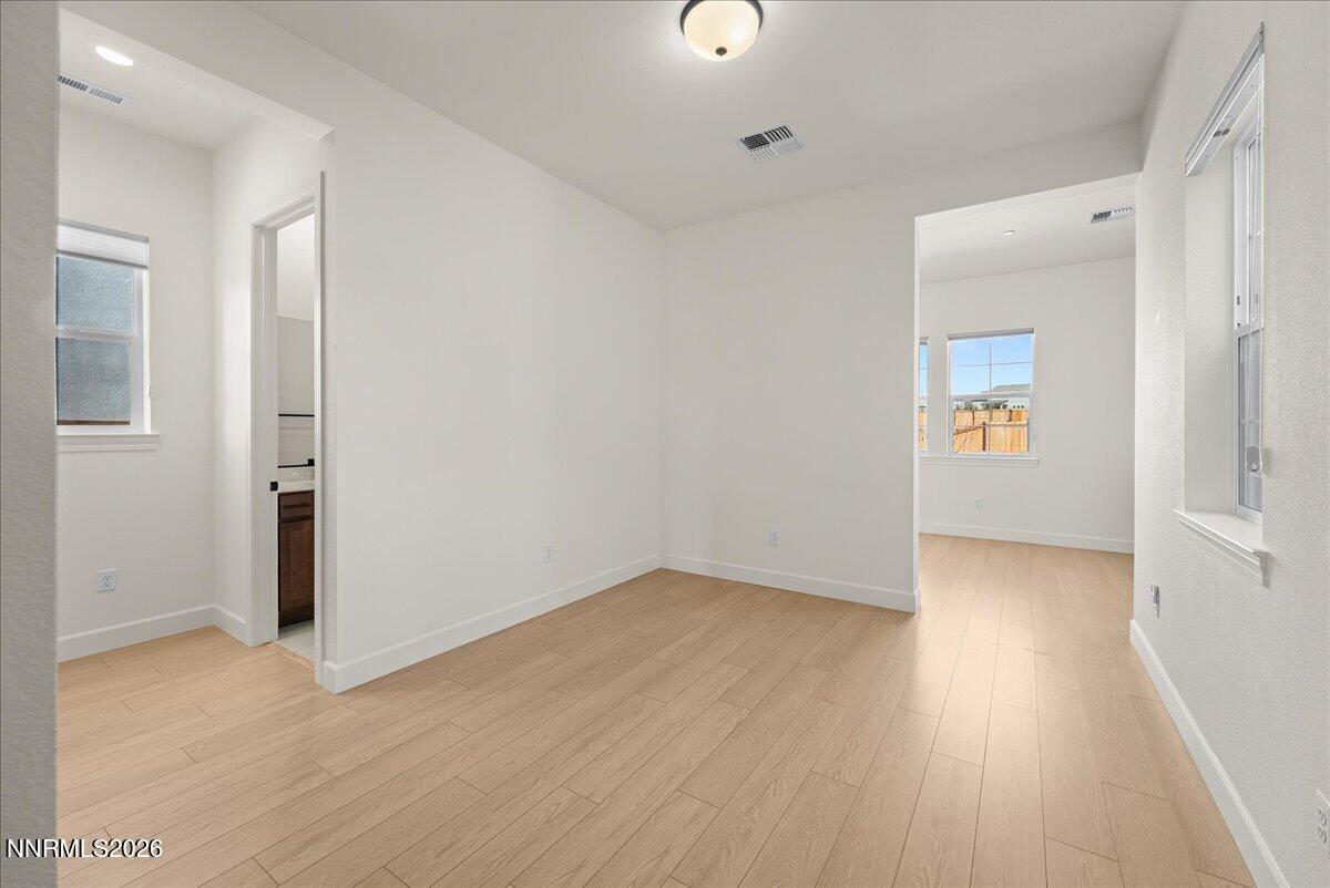 348 South Pah Rah Rdg Drive Sparks, NV 89441 - Photo 6 of 45 an empty room with wooden floor and way to kitchen
