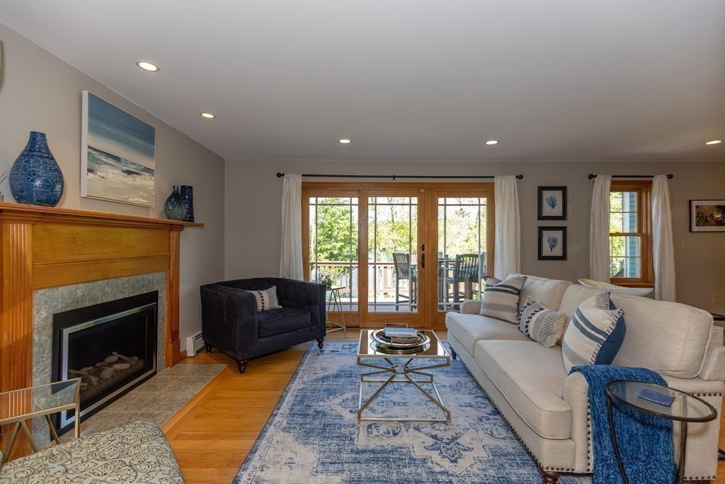 8 Merrimack River Road Groveland, MA 01834 - Photo 13 of 39 a living room with furniture and a fireplace