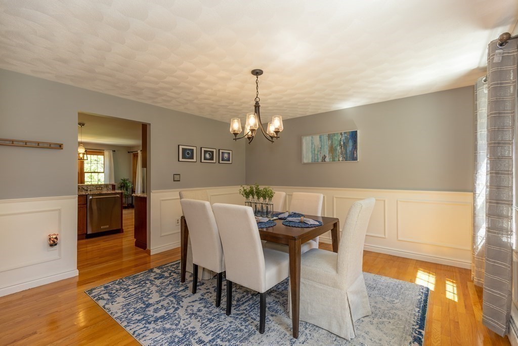 8 Merrimack River Road Groveland, MA 01834 - Photo 17 of 39 a view of a dining room with furniture and wooden floor