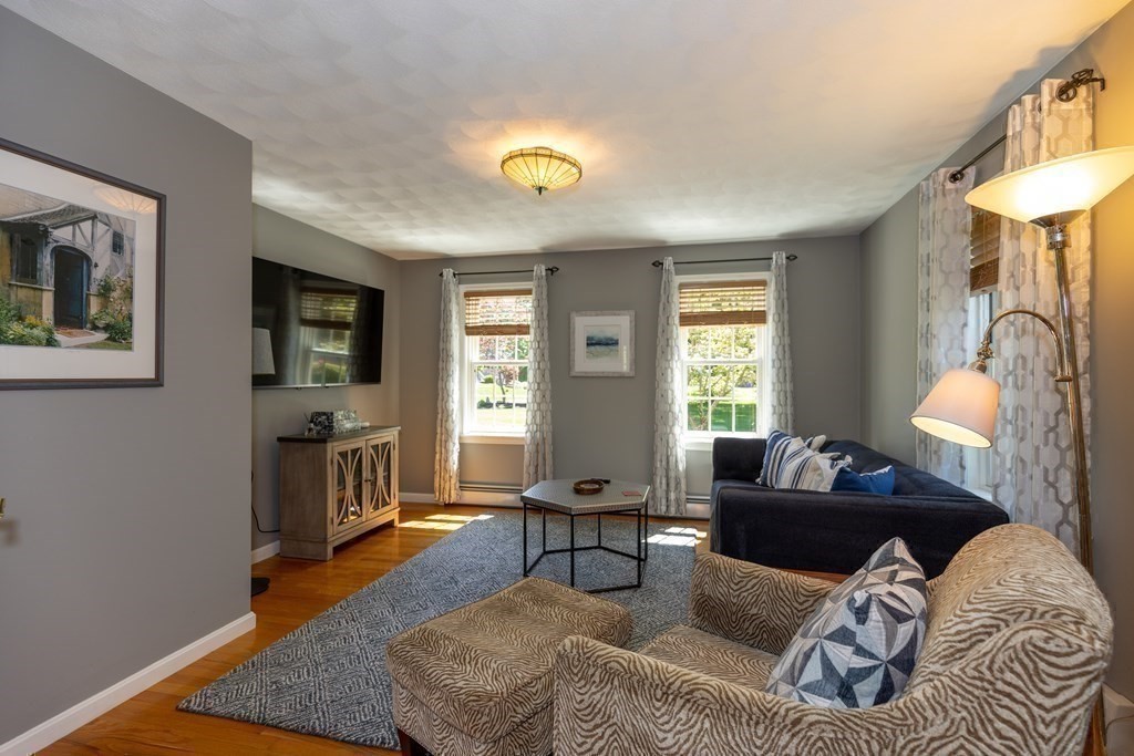 8 Merrimack River Road Groveland, MA 01834 - Photo 18 of 39 a living room with furniture a fireplace and a table