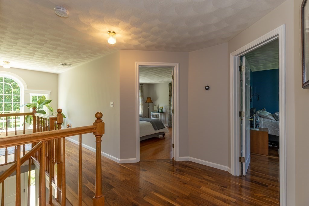 8 Merrimack River Road Groveland, MA 01834 - Photo 20 of 39 a view of a hallway with wooden floor and dining room