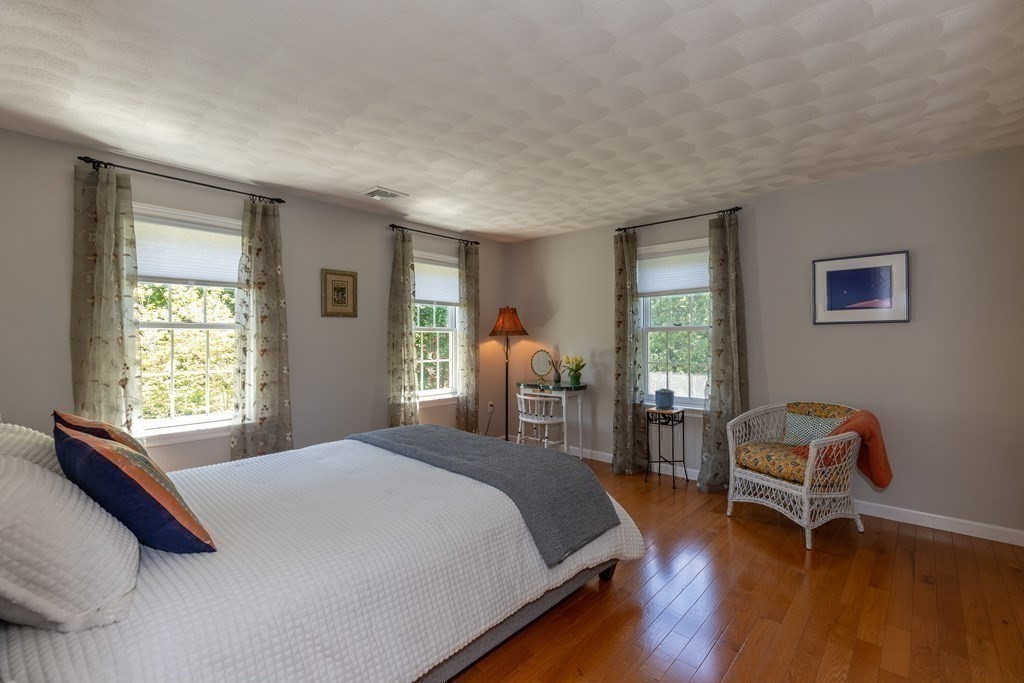 8 Merrimack River Road Groveland, MA 01834 - Photo 23 of 39 a bedroom with a bed and a chair