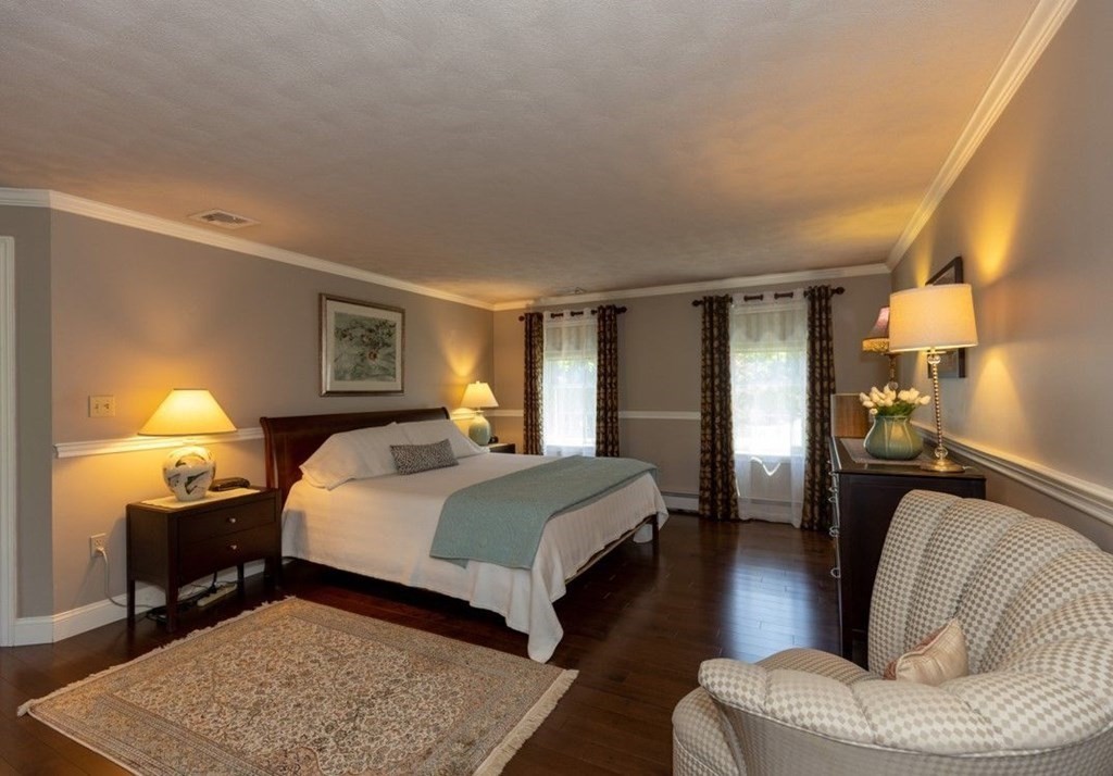 8 Merrimack River Road Groveland, MA 01834 - Photo 26 of 39 a bedroom with a bed and wooden floor