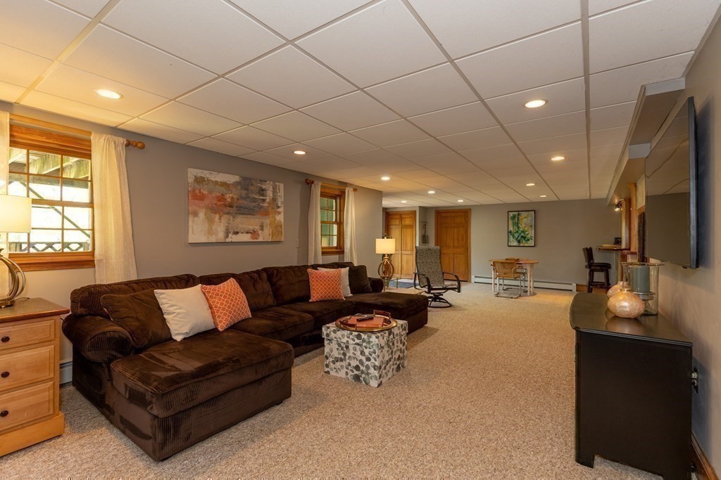 8 Merrimack River Road Groveland, MA 01834 - Photo 33 of 39 a living room with furniture and a flat screen tv