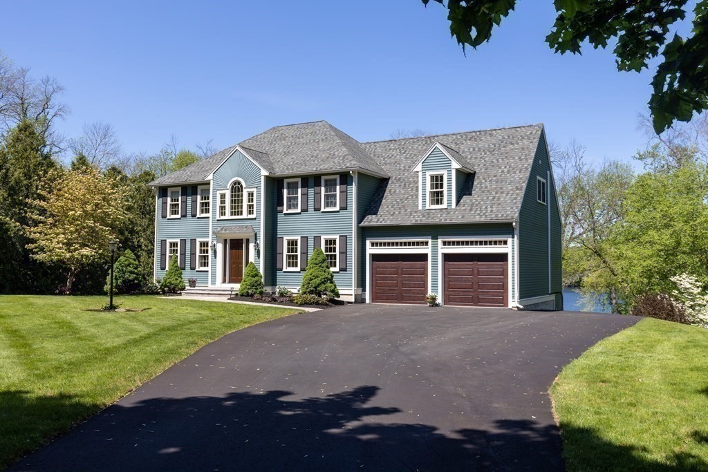 8 Merrimack River Road Groveland, MA 01834 - Photo 4 of 39 a front view of a house with a garden