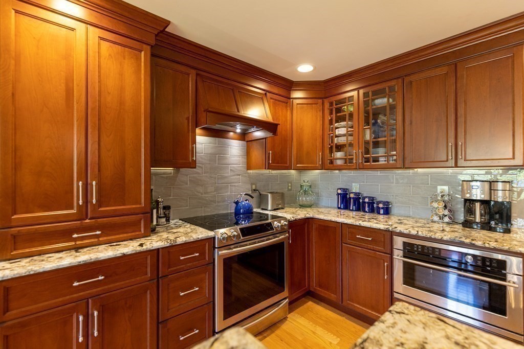 8 Merrimack River Road Groveland, MA 01834 - Photo 6 of 39 a kitchen with stainless steel appliances granite countertop a sink stove and cabinets