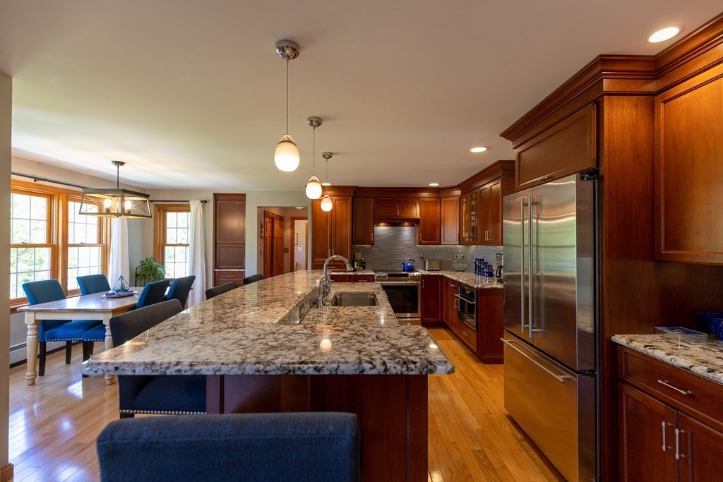 8 Merrimack River Road Groveland, MA 01834 - Photo 8 of 39 a kitchen with kitchen island granite countertop wooden cabinets and a counter top space