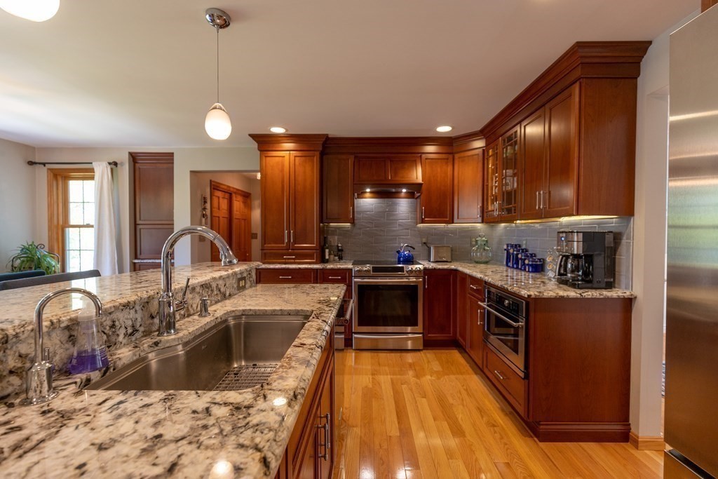 8 Merrimack River Road Groveland, MA 01834 - Photo 9 of 39 a kitchen with granite countertop a stove and a sink