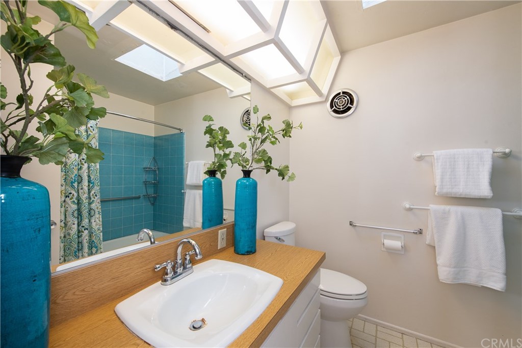 35261 Beach Road Dana Point, CA 92624 - Photo 21 of 34 a bathroom with a sink a toilet and mirror