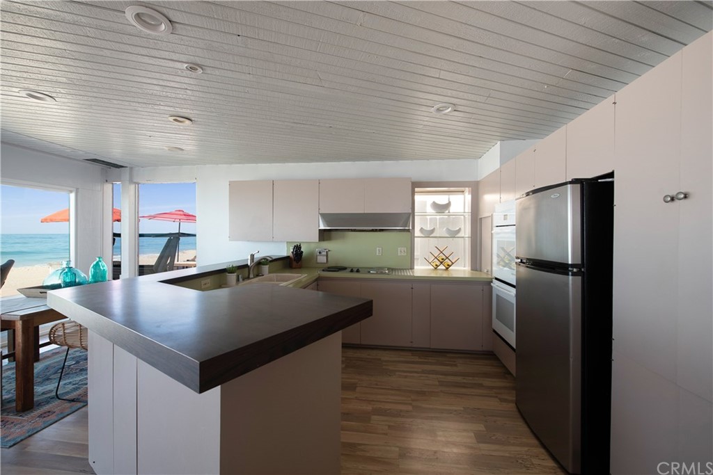 35261 Beach Road Dana Point, CA 92624 - Photo 9 of 34 a kitchen with refrigerator and cabinets