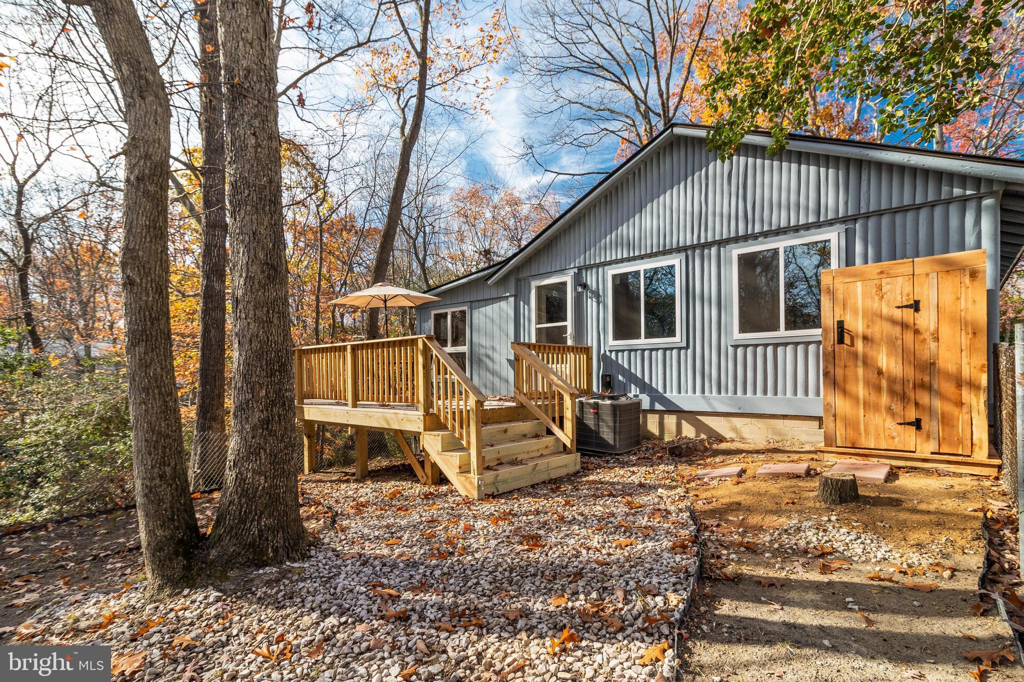 970 Eagle Point Lusby, MD 20657 - Photo 4 of 26 a view of a small house with trees in the background