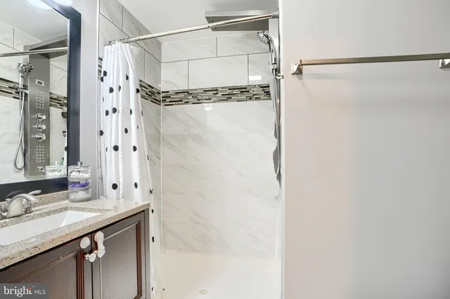 a bathroom with a shower and a sink