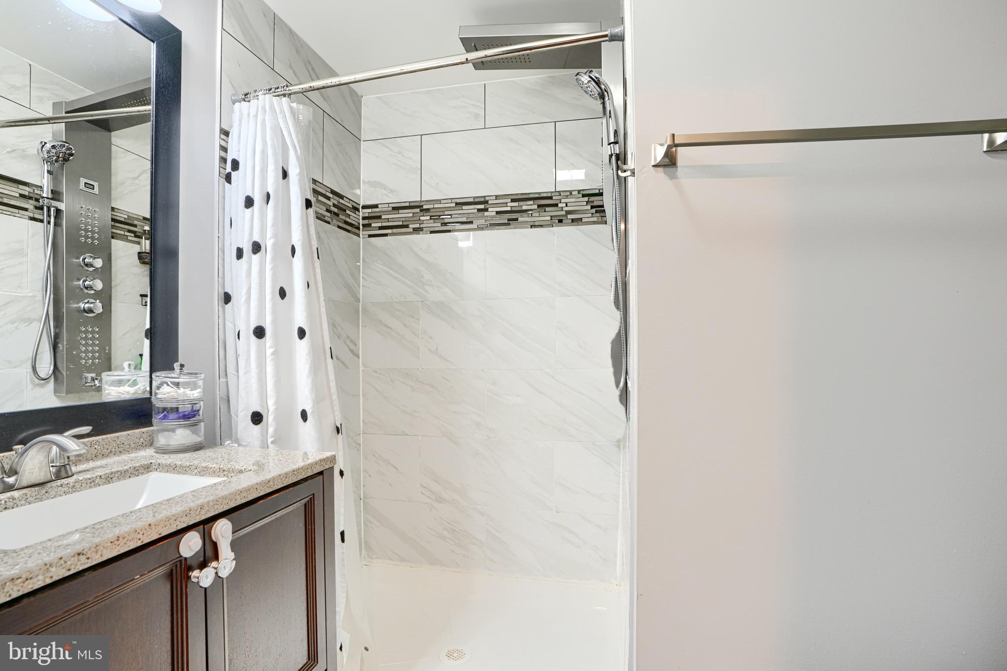 4054 Hilton Road Baltimore, MD 21215 - Photo 12 of 26 a bathroom with a shower and a sink