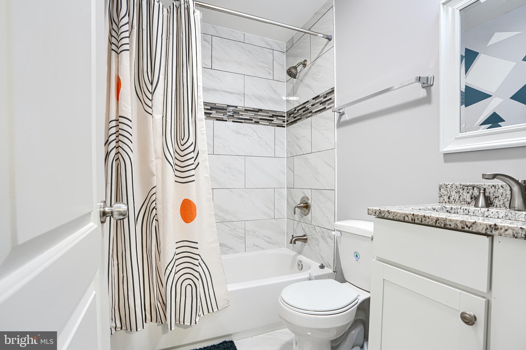 4054 Hilton Road Baltimore, MD 21215 - Photo 18 of 26 a bathroom with a sink a toilet and shower curtain