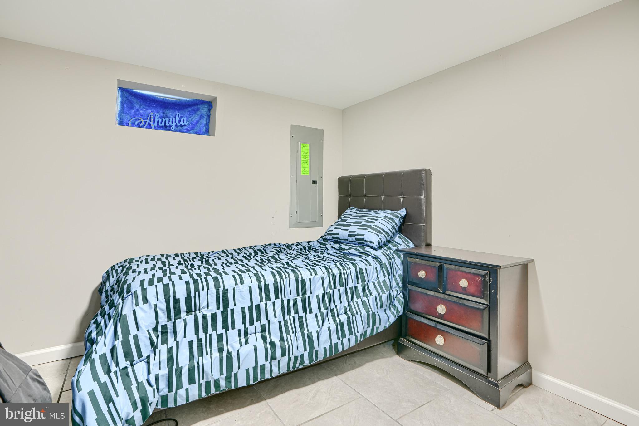 4054 Hilton Road Baltimore, MD 21215 - Photo 20 of 26 a bedroom with a bed and a wall painting