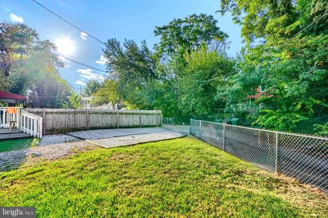 a view of a backyard with wooden fence