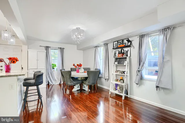 a living room with furniture and a book shelf