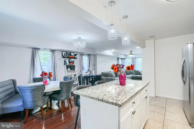 a kitchen island with granite countertop dining room and stainless steel appliances
