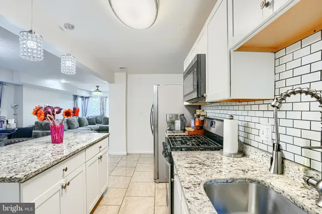 a kitchen with granite countertop a sink and a stove