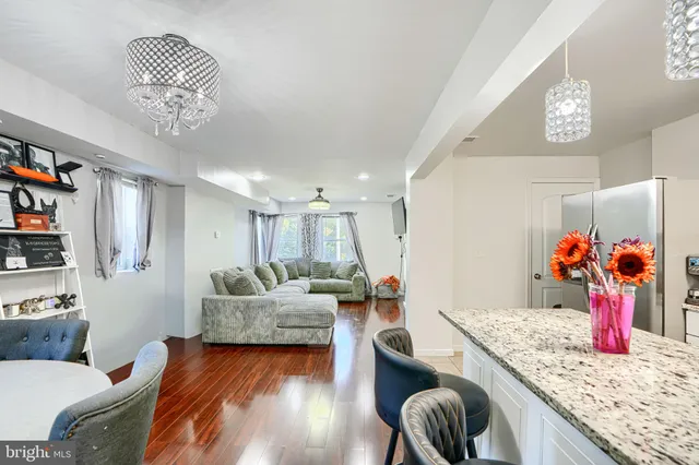 a living room with furniture and a chandelier